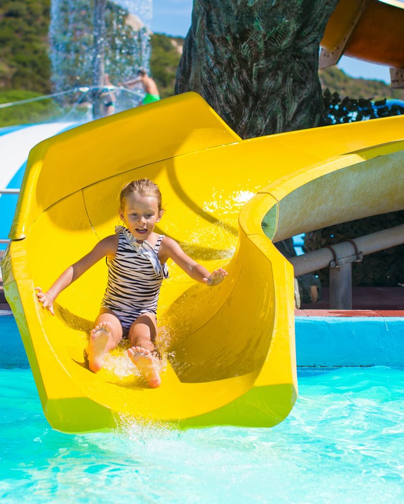 little-girl-on-water-slide-at-aquapark-during-summer-holiday.jpg